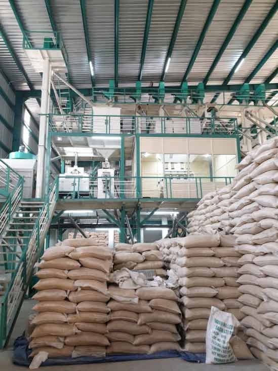 Interior of a modern rice mill with bagged rice